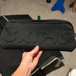 SKIMS Black Embossed Pouch